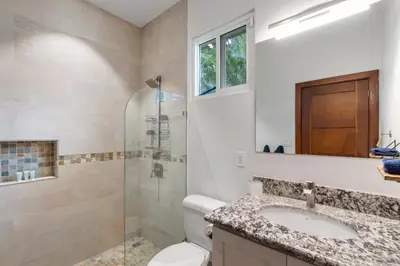 a bathroom with a toilet and a sink and a shower at Beautiful Home in a Gated Neighborhood Walking Distance to the Beach with Garden Views and a Pool in Brasilito