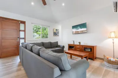 a living room with a couch and a table at Beautiful Home in a Gated Neighborhood Walking Distance to the Beach with Garden Views and a Pool in Brasilito