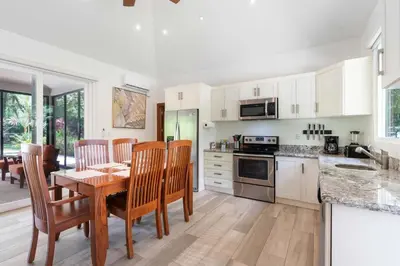 a kitchen with a table and chairs and a dining room at Beautiful Home in a Gated Neighborhood Walking Distance to the Beach with Garden Views and a Pool in Brasilito