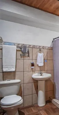 a bathroom with a toilet and a sink at Room A Heredia – Excellent Location in Flor