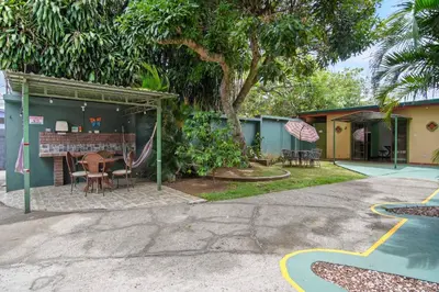 a house with a table and chairs in a yard at Room A Heredia – Excellent Location in Flor