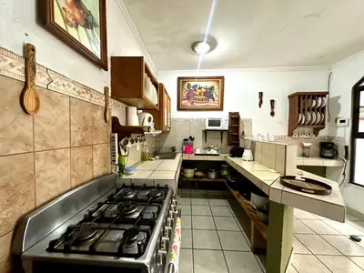 a kitchen with a stove top oven in a kitchen at Room A Heredia – Excellent Location in Flor