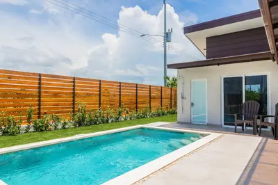 a swimming pool in the backyard of a house at Triskele Retreat - Casa Earth in Esterillos