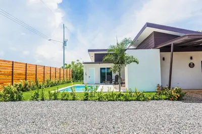 a house with a swimming pool and a fence at Triskele Retreat - Casa Earth in Esterillos