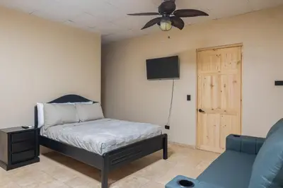 a bedroom with a bed and a ceiling fan at Marsol 2 in Uvita