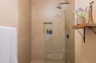 a bathroom with a shower with a glass door at Marsol 2 in Uvita