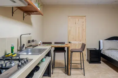 a kitchen with a sink and a stove and a couch at Marsol 2 in Uvita