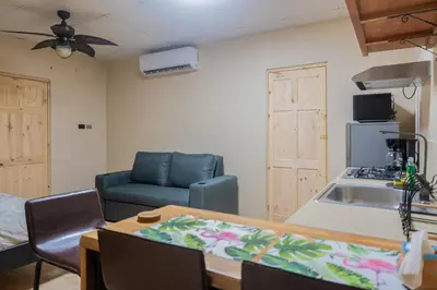 a kitchen and living room with a couch and a table at Marsol 2 in Uvita