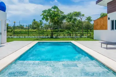 a swimming pool in the backyard of a house at Triskele Retreat - Casa Ocean in Esterillos