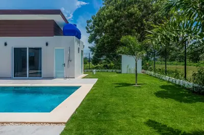 a villa with a swimming pool and a house at Triskele Retreat - Casa Ocean in Esterillos