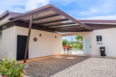 a garage with awning over a building at Triskele Retreat - Casa Ocean in Esterillos