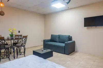 a living room with a blue couch and a table at Marsol 1 in Uvita