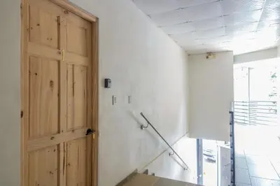 a room with a wooden door and a wall at Marsol 1 in Uvita