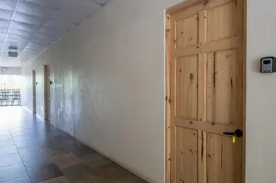 a hallway with a wooden door in a building at Marsol 1 in Uvita