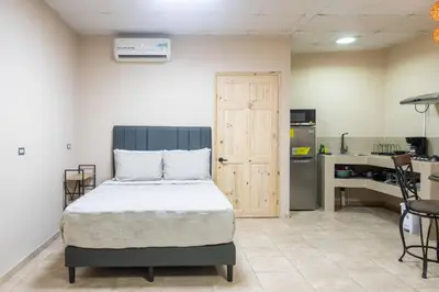 a bedroom with a bed and a kitchen at Marsol 3 in Uvita