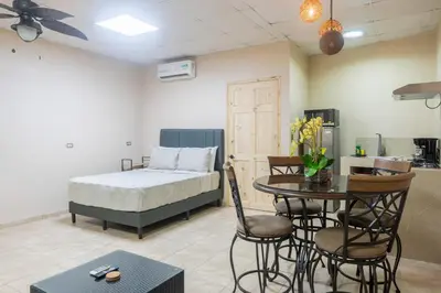 a bedroom with a bed and a table and chairs at Marsol 3 in Uvita