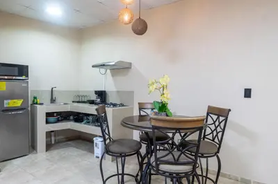 a kitchen with a table and chairs in a kitchen at Marsol 3 in Uvita