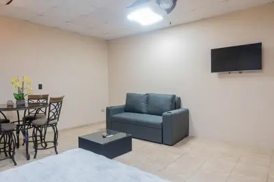 a living room with a blue chair and a table at Marsol 3 in Uvita
