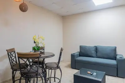a living room with a couch and a table and chairs at Marsol 3 in Uvita