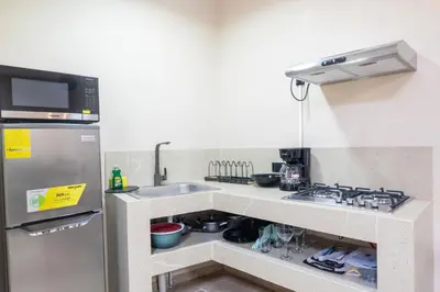 a small kitchen with a sink and a refrigerator at Marsol 3 in Uvita