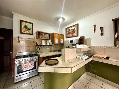 a large kitchen with a stove top oven at Room D Heredia – Great location in Flor