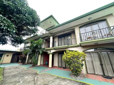 a large house with a driveway in front of it at Room D Heredia – Great location in Flor