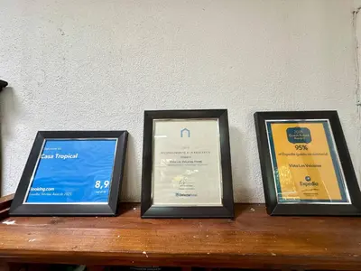three framed diplom certificates sitting on a wooden table at Room J Heredia – Comfort and Excellent Location in Flor