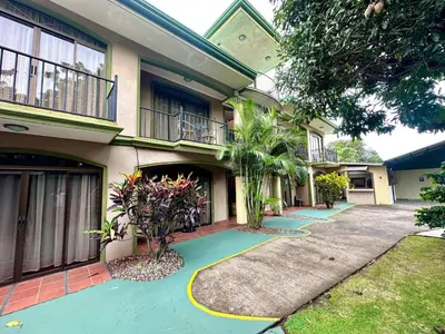 a house with a green driveway in front of it at Apartment F -G Heredia – Good Location in Flor