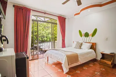 a bedroom with a bed and a large window at Relaxing H-I Heredia Apartment in Flor