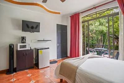 a bedroom with a bed and a balcony at Relaxing H-I Heredia Apartment in Flor