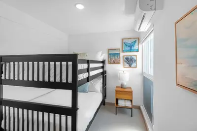 a bedroom with two bunk beds and a window at Contemporary Viva Jaco Residences Suite with Pool in Jacó