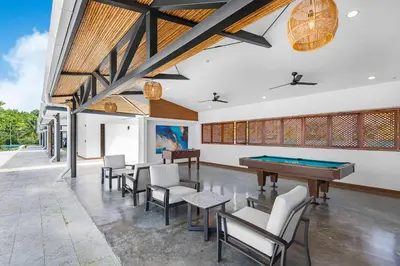 a room with a pool table and chairs at Contemporary Viva Jaco Residences Suite with Pool in Jacó