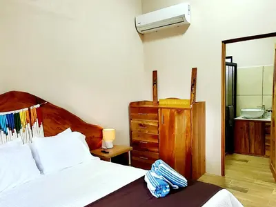 a bedroom with a bed and a dresser and a mirror at Nature Observatory Studio with Private Pool in Chachagua