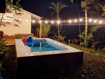 a ping pong table in a backyard at night at Nature Observatory Studio with Private Pool in Chachagua