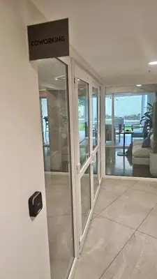 a revolving door in a building with a sign on it at Stunning Beachfront 1BR Suite with Ocean View in Jacó