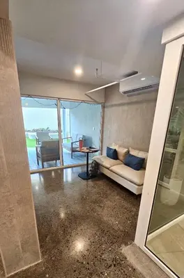 a living room with a couch and a table at Stunning Beachfront 1BR Suite with Ocean View in Jacó