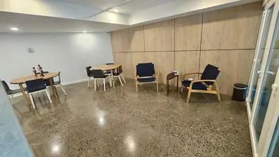 a room with two tables and chairs and a wall at Stunning Beachfront 1BR Suite with Ocean View in Jacó