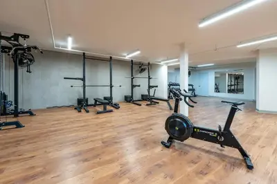a gym with a row of treadmills and machines at Stunning Beachfront 1BR Suite with Ocean View in Jacó