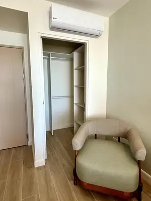 a room with a chair and a closet at Stunning Beachfront 1BR Suite with Ocean View in Jacó
