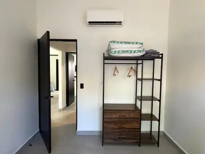 a room with a mirror and a shelf with shoes at House of the Orange Cat in Coco