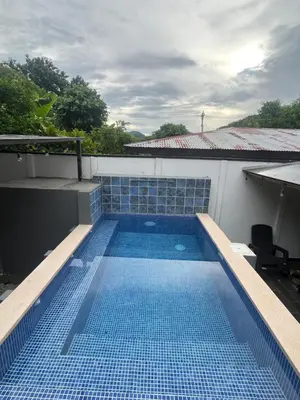 a swimming pool on the roof of a building at House of the Orange Cat in Coco