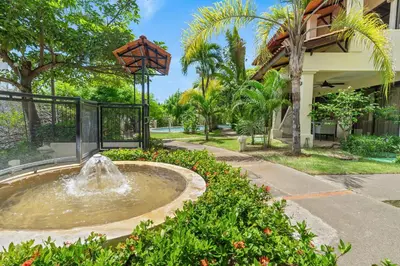 a fountain in a park in front of a building at The Sky Deck Condo 2bed25bath in Coco