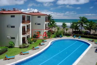 an aerial view of a resort with a swimming pool and the beach at Bahia Azul 3A in Jacó