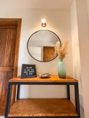 a table with a mirror and a vase on it at Casa Nara - Sunset View l Forest Deck - Mountain House in Monteverde Costa Rica