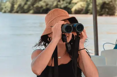 a woman in a hat taking a picture with a camera at Salty Living - Tamarindo Hills in Tamarindo