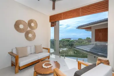 a living room with a couch and a table at Salty Living - Tamarindo Hills in Tamarindo