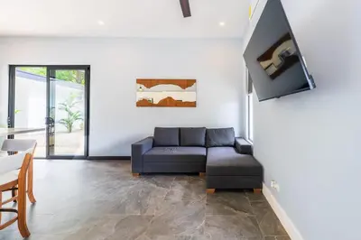 a living room with a couch and a table at Serenity Surf Villa in Playa Grande