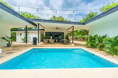 an image of a swimming pool in a house at Serenity Surf Villa in Playa Grande