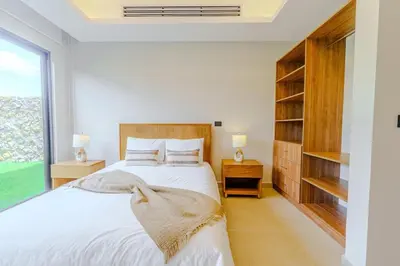 a white bedroom with a large bed and a window at Casa Nimbu - Hacienda Pinilla in Tamarindo