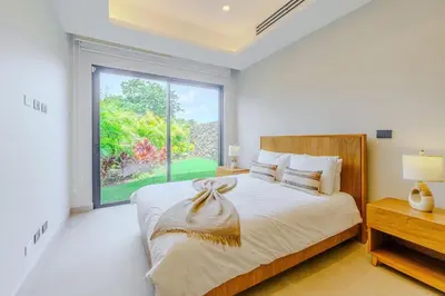 a bedroom with a bed and a large window at Casa Nimbu - Hacienda Pinilla in Tamarindo